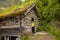 Amazing little wooden small house next to a waterfall on the dock of Hellesylt, child playing in the house