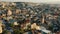 Amazing long aerial zoom in panorama of beautiful small sunny ancient town among historic rocks in summer Cappadocia.