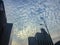 Amazing mammatus clouds over Bangkok, Thailand, with tall buildings foreground.