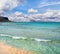 Amazing Mediterranean beach, clear blue calm sea, island in the background and beautiful sky