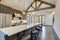 Amazing modern and rustic luxury kitchen with vaulted ceiling and wooden beams, long island with white quarts countertop