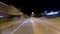 Amazing motion timelapse of the night rush drive. Speedy car driving the road with a lot of lights and passing by houses