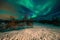 Amazing multicolored Aurora Borealis also know as Northern Lights in the night sky over Lofoten landscape.