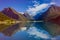 Amazing nature view with boat, fjord and mountains. Beautiful reflection. Norway.