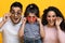 Amazing Offer. Portrait Of Excited Arab Family Of Three Wearing Colorful Sunglasses