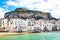 Amazing old houses on the coast of Tyrrhenian sea in beautiful Cefalu, Sicily, Italy. Behind the buildings marvelous rock