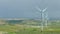 Amazing panorama of beautiful landscape, wind turbines rotating, green hills