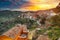 Amazing Panorama of the belltower and the village in the valley at early sunrise