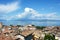 Amazing panorama from Desenzano castle on Lake Garda with old city roofs, mountains, white clouds and sailboats on the lake, Desen