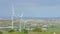 Amazing panorama of green rural landscape, mountains on horizon, wind farm
