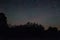 Amazing panorama of stars in the night sky with the Milky Way over the forest . starry sky. night shooting