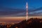 Amazing panoramic view of High Castle hill with illuminated TV tower against picturesque sunset sky, Lviv, Ukraine