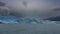 The amazing Perito Moreno glacier. A wall of blue ice over a turquoise glacial lake.