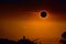 amazing phenomenon of total sun eclipse over silhouette tree and sunset sky