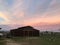 Amazing pink and orange sky Sunrise with barn