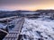 Amazing polar purple frosty dawn. Wooden pedestal to the house above the tundra. Old weather station. Teriberka