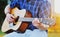 Amazing portrait of young man playing guitar outdoor