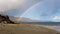 Amazing Rainbow over Staffin bay, the dinosaur bay, on a cloudy day - Isle of Skye, Scotland