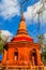 Amazing red pagoda with the Buddha image against blue sky background at Wat Khao Rup Chang Temple. Located along the Phichit-Tapha