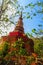 Amazing red pagoda with the Buddha image against blue sky background at Wat Khao Rup Chang Temple. Located along the Phichit-Tapha