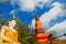 Amazing red pagoda with the Buddha image against blue sky background at Wat Khao Rup Chang Temple. Located along the Phichit-Tapha