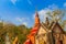 Amazing red pagoda with the Buddha image against blue sky background at Wat Khao Rup Chang Temple. Located along the Phichit-Tapha