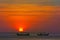 Amazing red sun sunset with fisherman`s boats silhouettes, Kuta beach, Bali