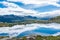 Amazing reflection over a lake in the mountains of Trolltunga hike,  Norway