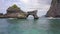 Amazing Rock Arch Island in the Sea at Atuh Beach in Nusa Penida, Indonesia. 4K Aerial.