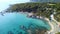 Amazing scene of sandy beach with beach bar and rocks on the coastline and exotic turquoise sea. Aerial view