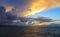 Amazing scenic landscape taken during wonerful sunset on sea. island Crete in background with clouds and water in red