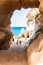 Amazing seascape view from unique sea cave on famous Rotonda beach. Tourists walking through the grotto, resting on small beach.