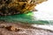 Amazing seascape view from unique sea cave overhanging above water on famous Cala Bianca beach scenic surroundings. Crystal clear