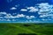 Amazing shot of beautiful grassland with hills on a cloudy sky background