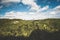 Amazing shot of the green landscapes and thick forests under the cloudy sky at daytime