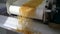 Amazing shot raw pasta macaroni running steel conveyor belt on pasta factory.