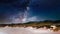 Amazing shot of a sandy landscape on a blue sky background full of stars