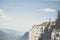 Amazing shot of an unrecognizable woman standing on the edge of a cliff and admiring the view