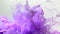 Amazing slow motion light purple watercolor ink on a white background