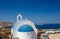 Amazing small white church  on blue background of sky and Idylic Mediterranean Sea