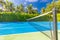 Amazing sport and recreational background as tennis court on tropical landscape, palm trees and blue sky. Sports in tropic concept