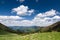 Amazing spring mountain landscape with blue sky and clouds