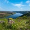 Amazing spring view on the Dnister River Canyon with picturesque rocks, fields, flowers. This place named Shyshkovi Gorby,