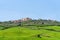 Amazing spring view of medieval small town with cypress trees and colorful spring flowers in Tuscany, Italy. Typical Tuscany