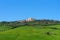 Amazing spring view of medieval small town with cypress trees and colorful spring flowers in Tuscany, Italy. Typical Tuscany