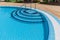 Amazing stylish modern blue ceramic tiles swimming pool entrance, with crystal azure clear turquoise water