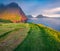 Amazing summer scene from Sunset Viewpoint in Gasadalur village. Fantastic evening landscape of Vagar island with Tindholmur cliff