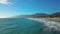 Amazing sunny day. Aerial drone view drone is flying over beach upward waves