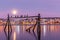 Amazing sunrise with amazing magenta color and moon over Tromso, Norway. Fisherman`s building . Polar night. long shutter speed