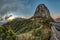 Amazing sunrise near Los roques and famous Agando rock near Garajonay Park at La Gomera. Half moon on a background of gray and